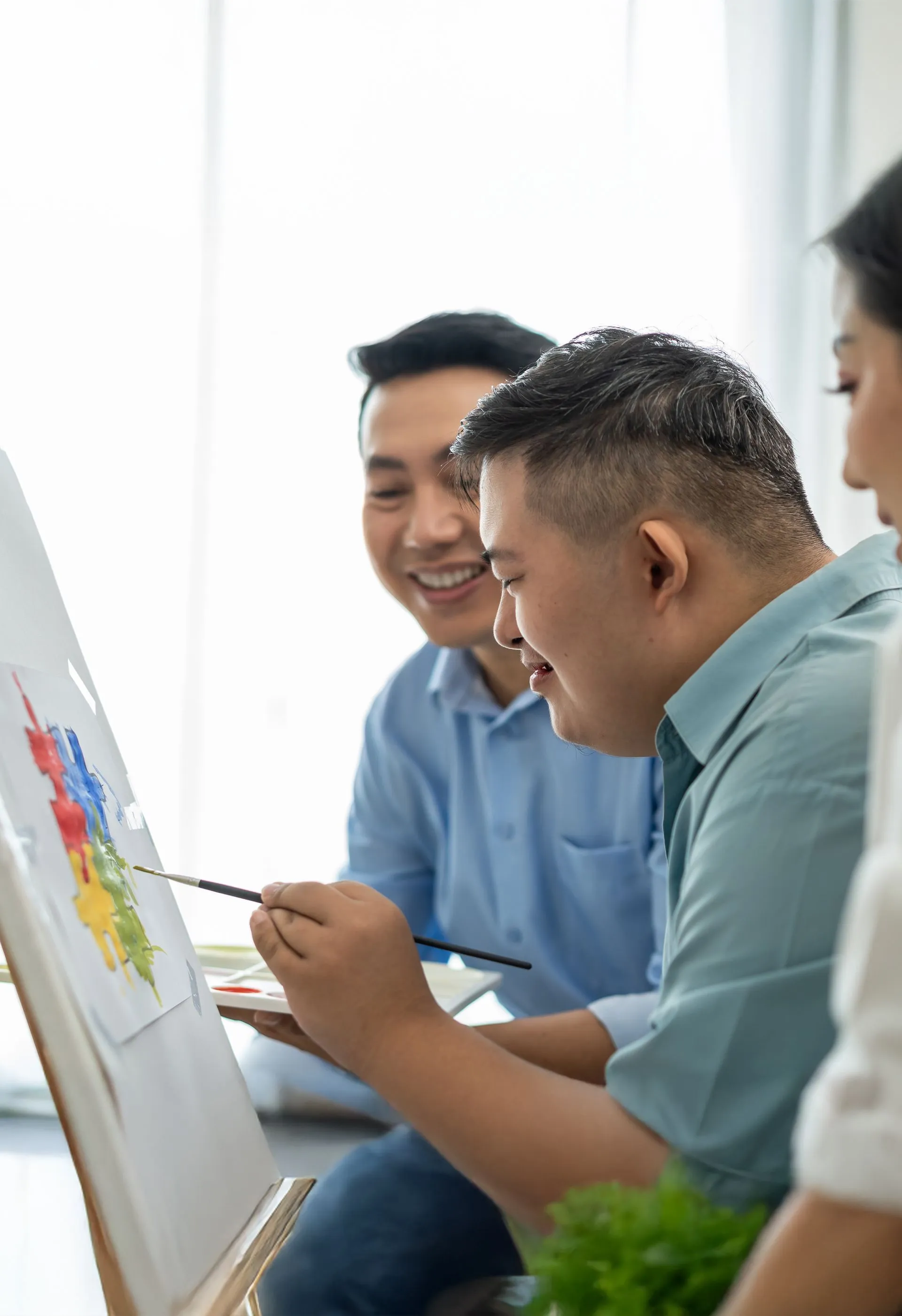 Two community members engaged in a creative activity together